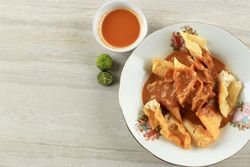 Top view of deep fried fish dumplings with peanut sauce and copy space
