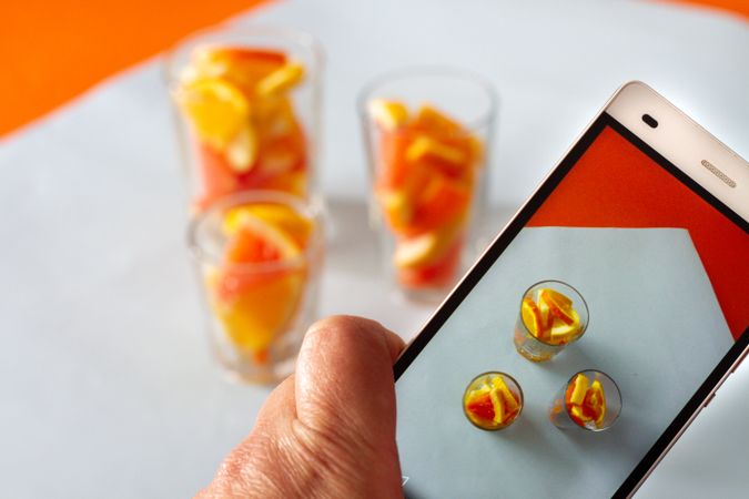 Photo of sliced citrus fruits on mobile phone