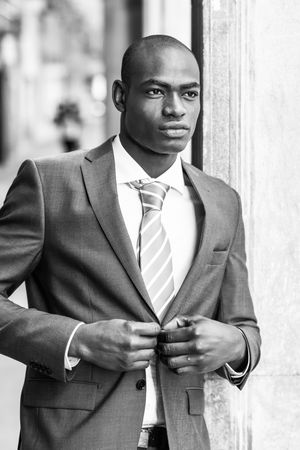 B&W picture of male adjusting his business suit