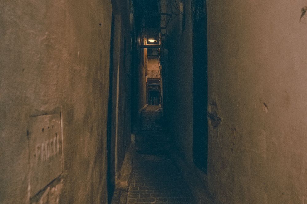 Old narrow street of town at night