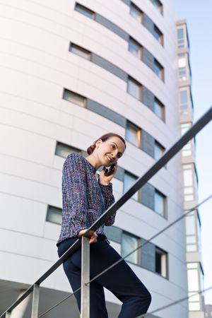 Smiling businesswoman answering phone call