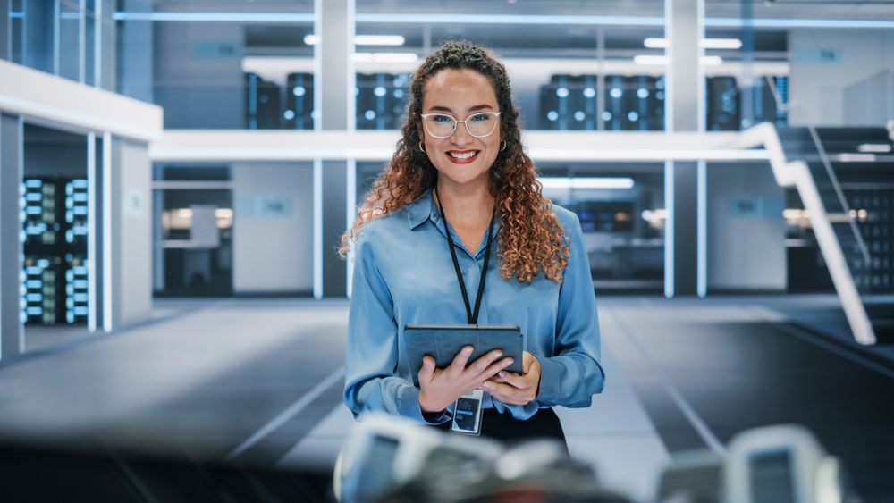 Portrait of a Latina Female Wearing Smart Corporate Shirt and Glasses, Looking at Camera and Smiling.