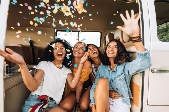 Group of women with confetti in a van