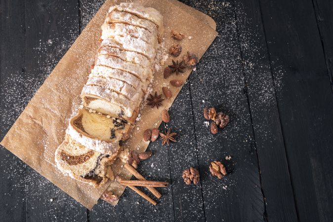 Top view of dessert bread with poppy seeds and walnuts on rustic table