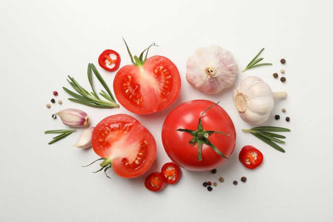 Tomatoes and ingredients on neutral background, top view