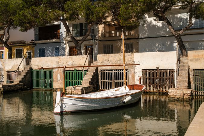 Boat moored near stone house