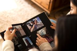People watching a photo album of themselves