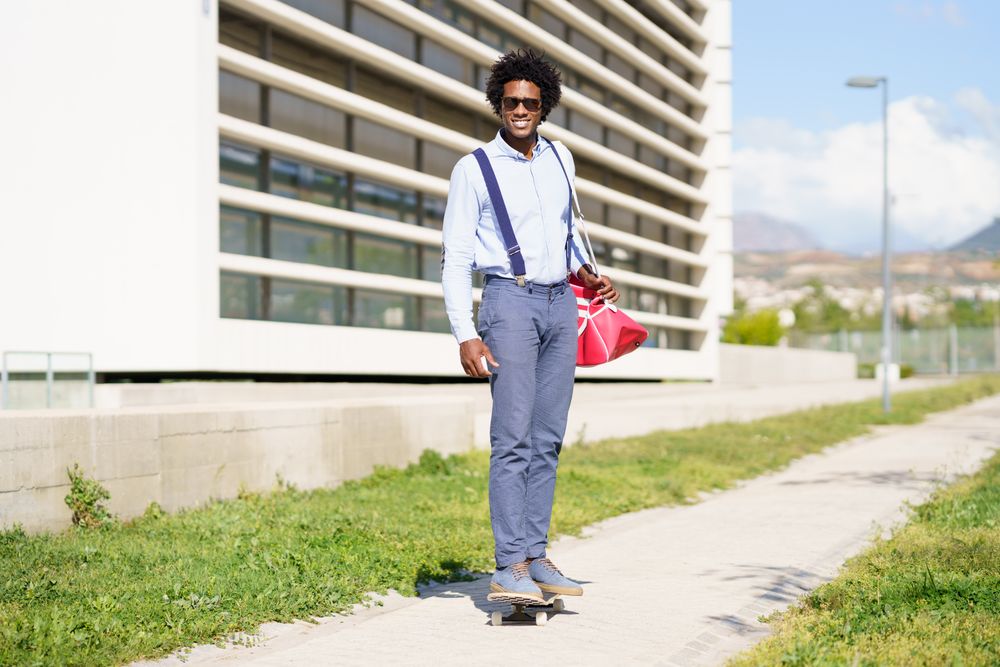 Man riding skateboard outside office building