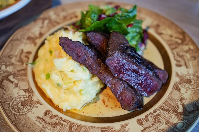 Appetizing beef with mashed potatoes and herbs