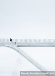 Person walking on light colored bridge 48AZJb