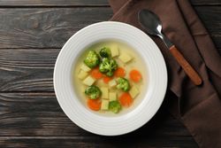 Potato, carrot and broccoli soup on table