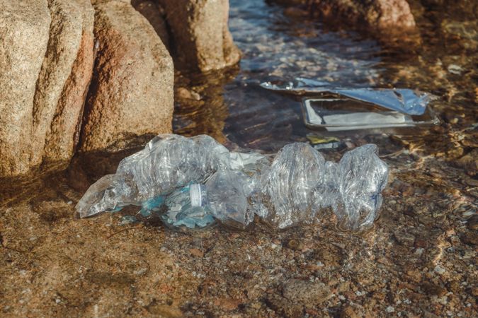 Plastic bottle lying on seashore