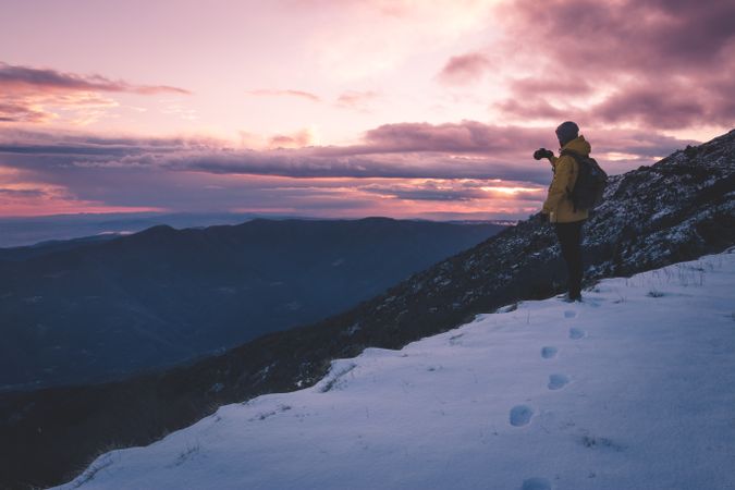Anonymous tourist on snowy mountain