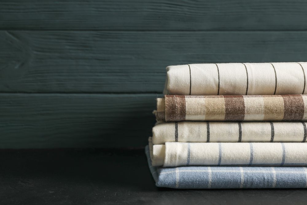 Stack of fabric napkins on table, space for text
