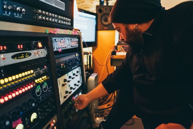 Man adjusting sound control in a studio