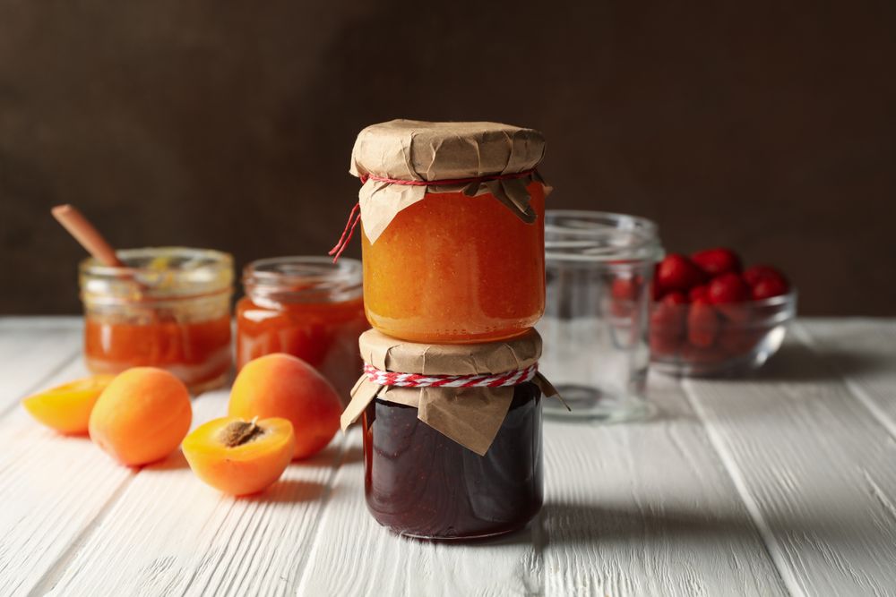 Composition with jam on wooden table. Sweet breakfast