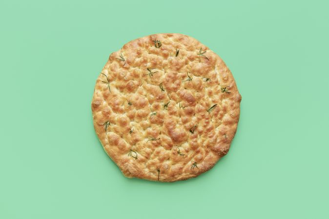 Focaccia top view, on a green background