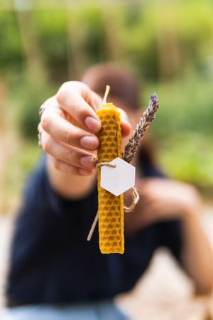 Unrecognizable woman with handmade beeswax candle