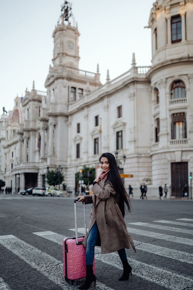Asian tourist on sidewalk in city