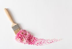 Layout made paint brush with pink flowers streak on light background