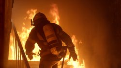 Firefighter running toward fire