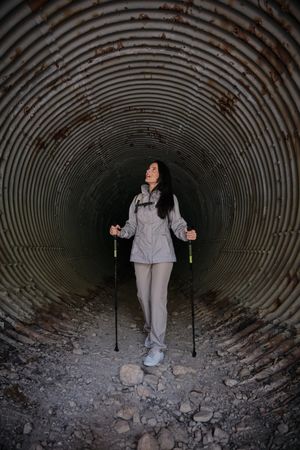 Active Hispanic woman in old tunnel