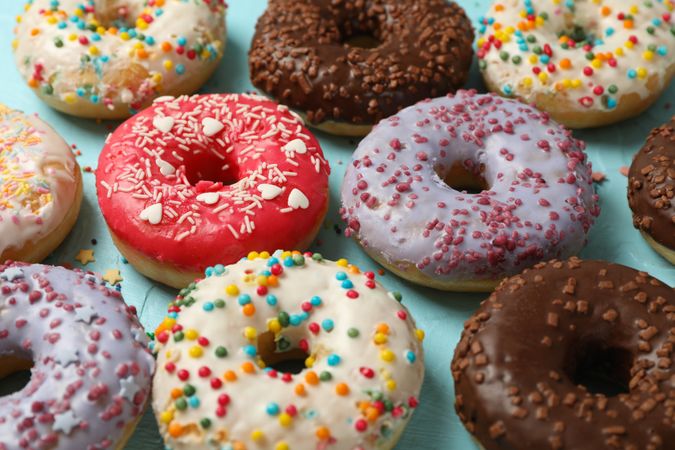 Tasty donuts on blue background, close up