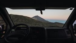 View of mountain through window of car