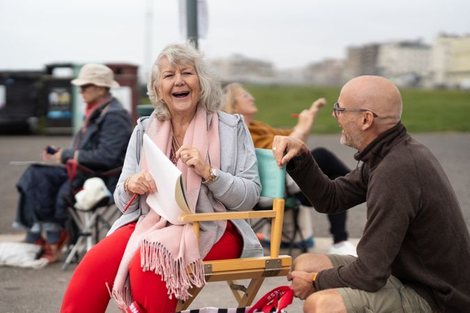 Woman sitting outside in park at drawing class with instructor