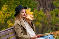 Woman on park bench in autumn