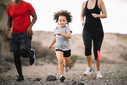 Active diverse family running on nature