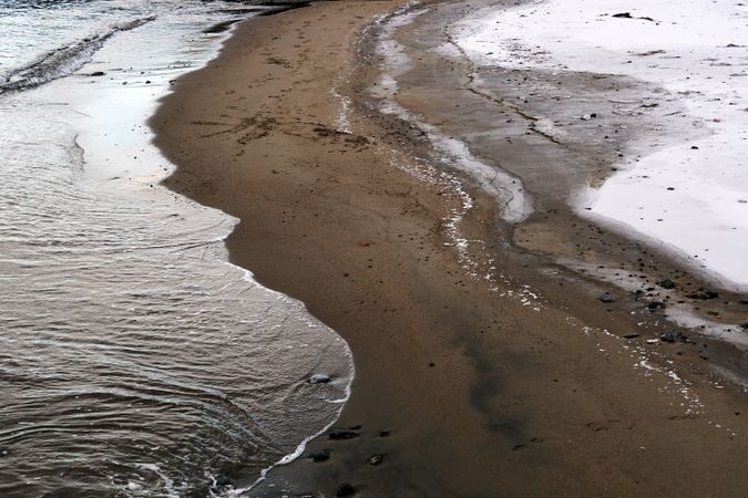 wet sandy shore on sunny day in beach