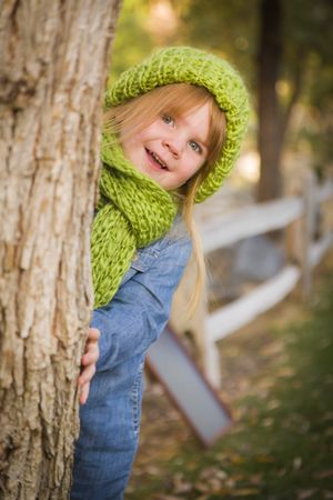 Portrait of Cute Young Girl Wearing Green Scarf and Hat