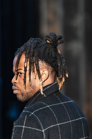 Stylish Black man with dreadlocks in buns