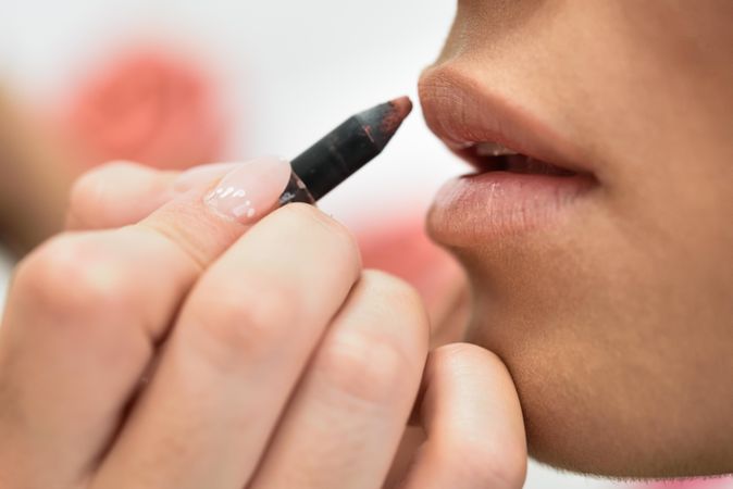 Woman having lipliner applied by a professional