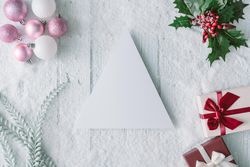Blank tree on snowy wooden table with festive decorations