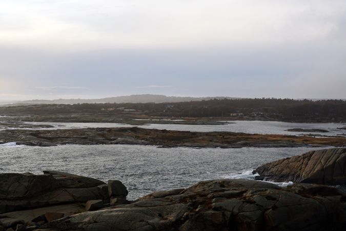 Rocky seashore and dark wavy sea in dusk