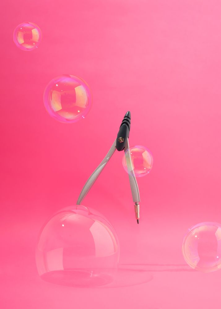 School compass suspended with bubbles