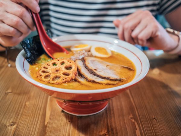 Female eating Japanese dish