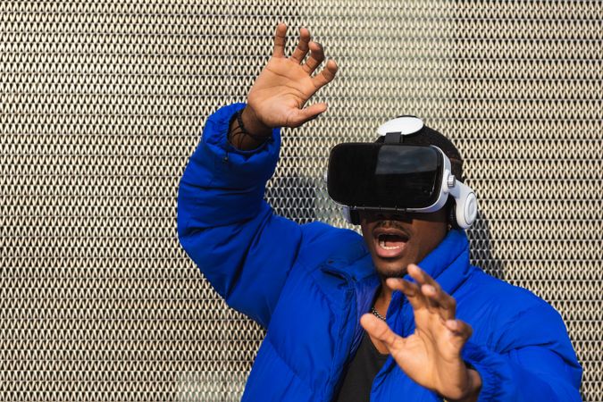 Black man experiencing virtual reality in city