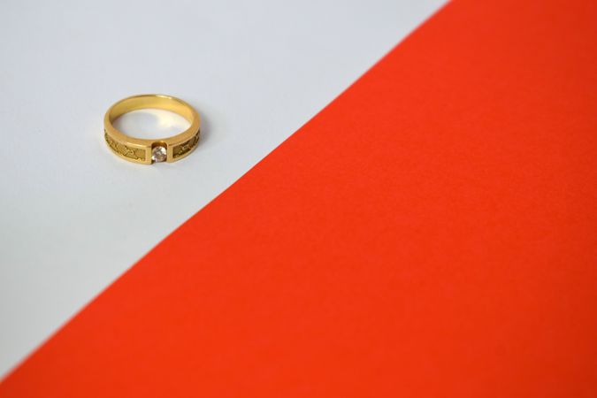 One diamond gold ring on duotone background with copy space