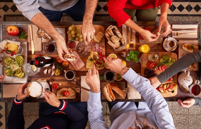 Anonymous friends having appetizers at table