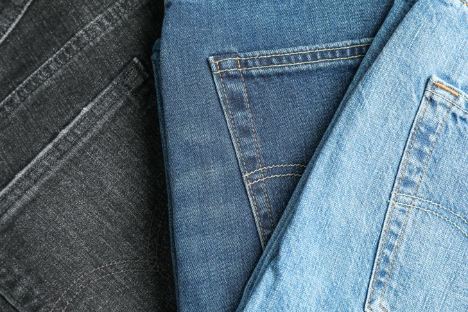 Jeans of different colors as background, space for text