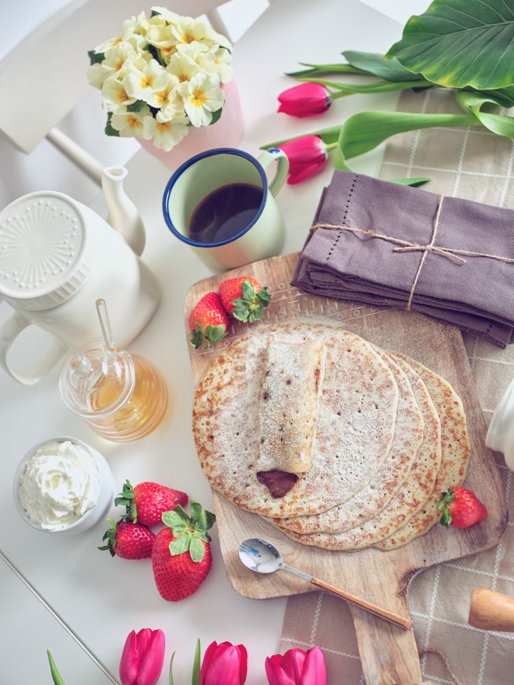 Delicious tasty homemade crepes on kitchen desk