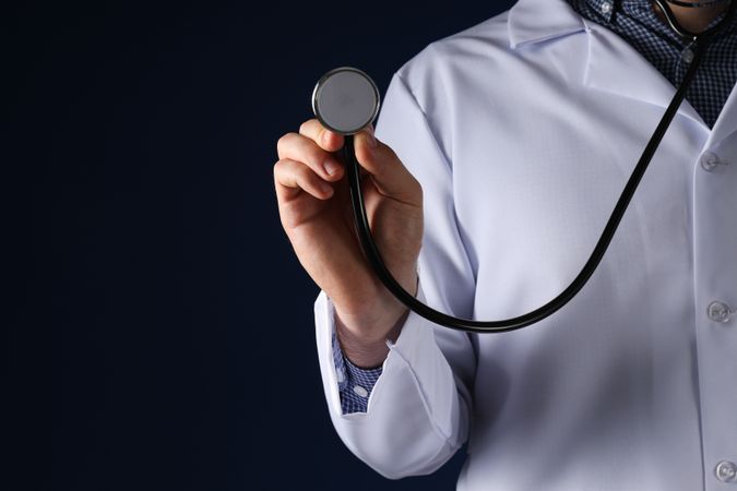A stethoscope in the hands of a doctor
