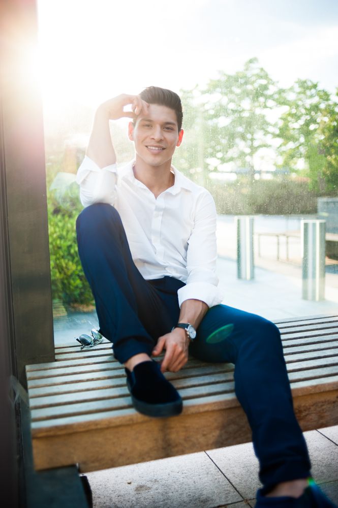 Smiling modern man on bench