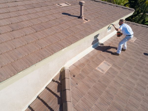 Professional Painter Using A Brush to Paint House Fascia