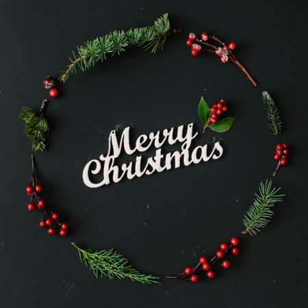 Christmas wreath made of winter items on dark background