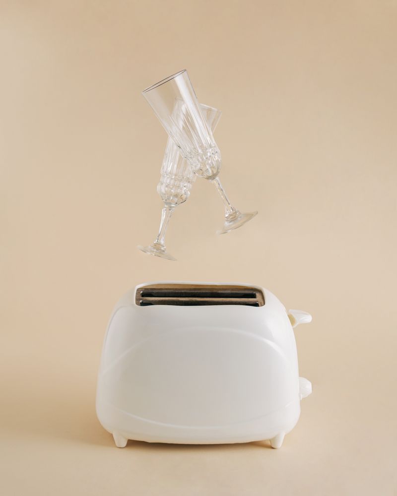 Champagne glasses suspended above a toaster