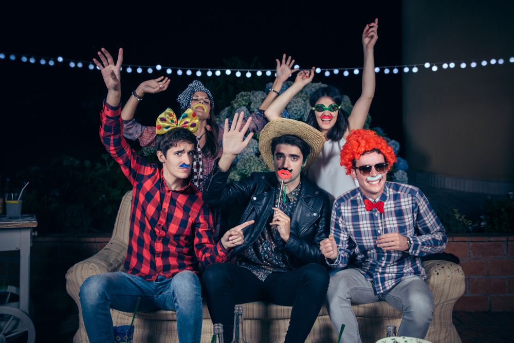 Happy friends in silly costumes at a party